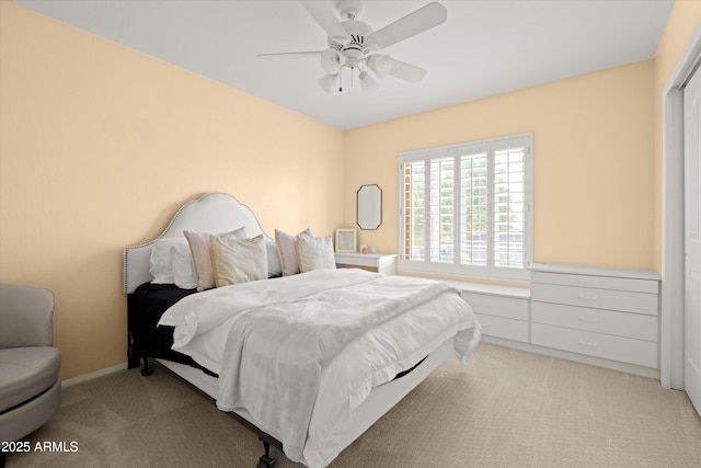 bedroom with light carpet and ceiling fan