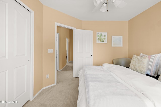 carpeted bedroom with ceiling fan and a closet