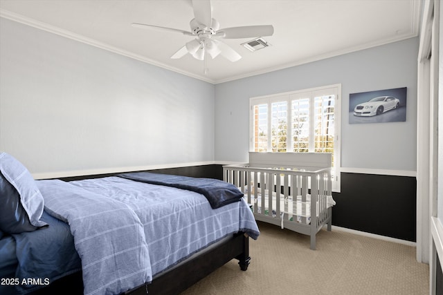 bedroom with ceiling fan, crown molding, and carpet