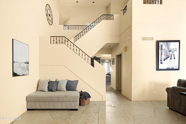 staircase featuring a high ceiling