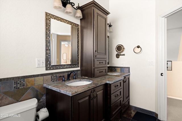 bathroom featuring toilet and vanity