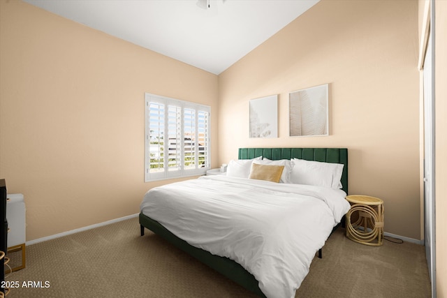 carpeted bedroom featuring lofted ceiling