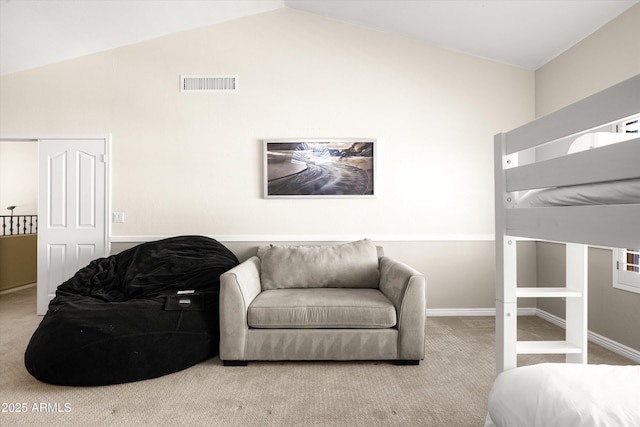 bedroom featuring light colored carpet and lofted ceiling