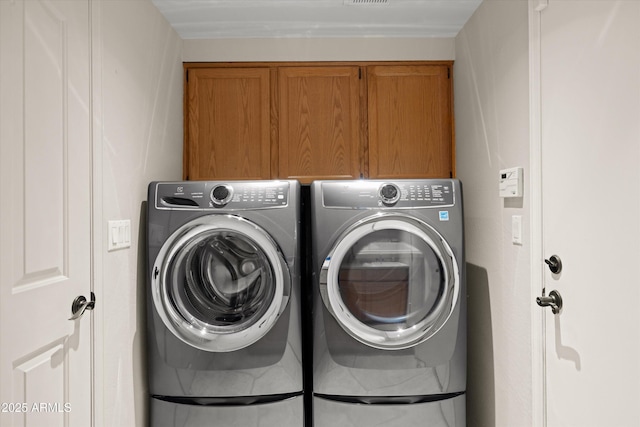 laundry room with cabinets and independent washer and dryer