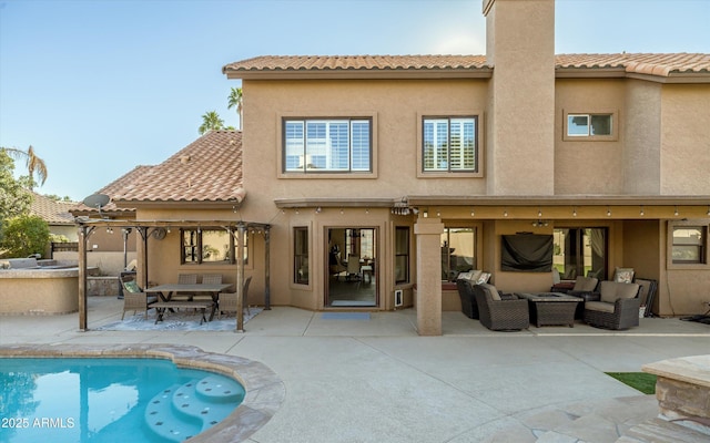 back of house with a patio area and an outdoor living space