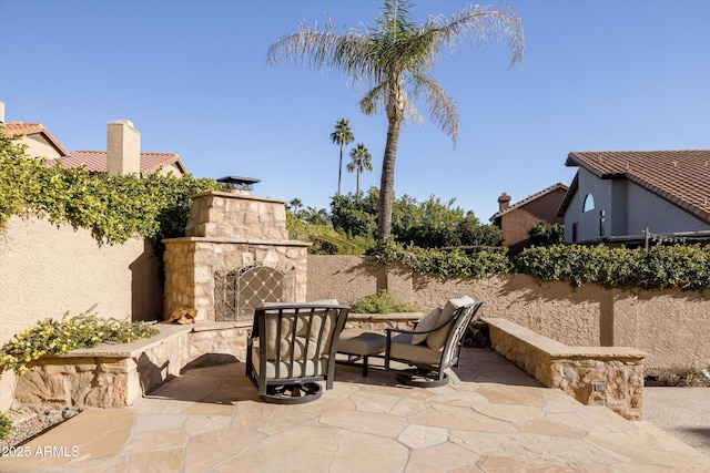 view of patio featuring an outdoor stone fireplace