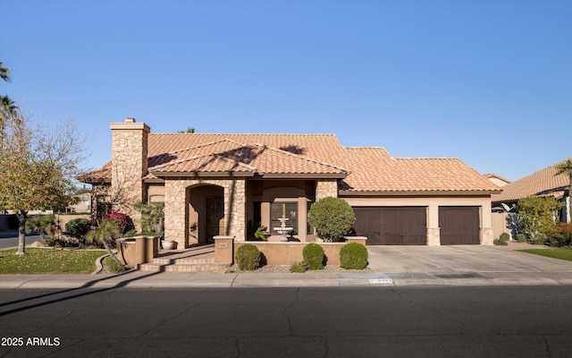 mediterranean / spanish house with a garage