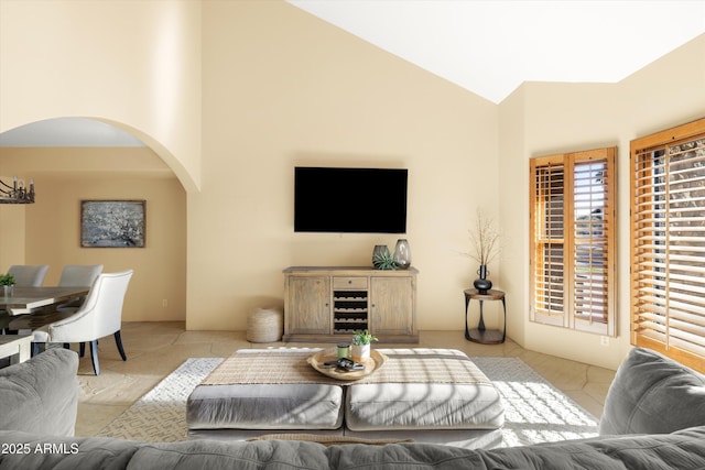 living room with lofted ceiling and a chandelier