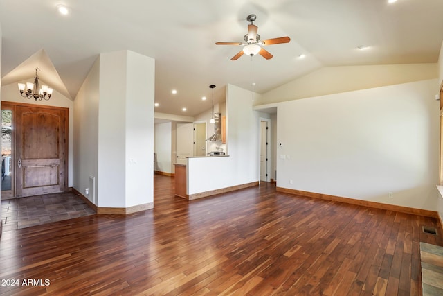 unfurnished living room featuring ceiling fan with notable chandelier, dark wood-type flooring, and vaulted ceiling