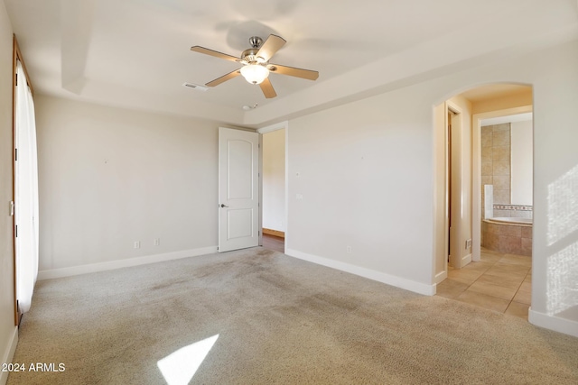 unfurnished room featuring light carpet and ceiling fan