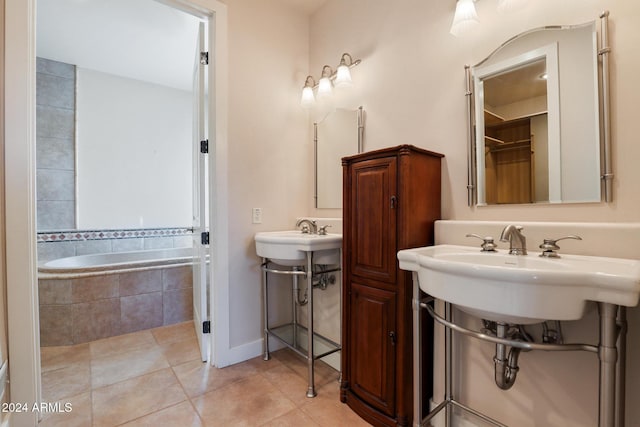 bathroom with tile patterned flooring and a relaxing tiled tub