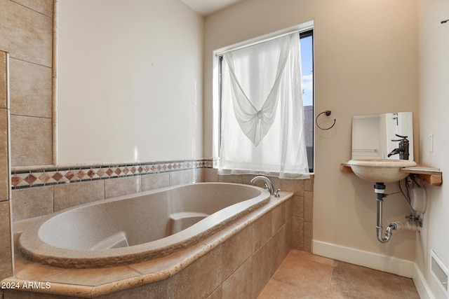 bathroom featuring tile patterned flooring and tiled tub