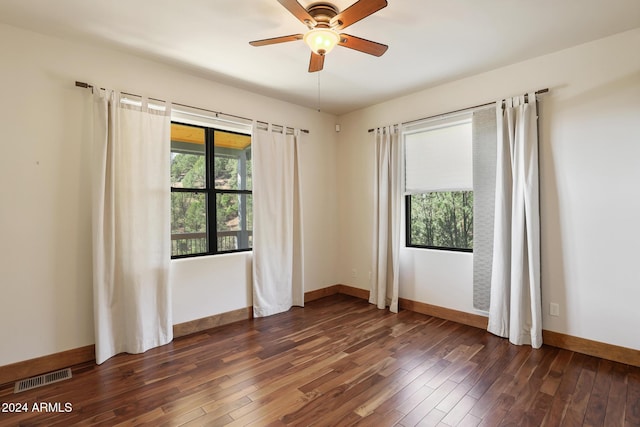 empty room with ceiling fan and dark hardwood / wood-style floors