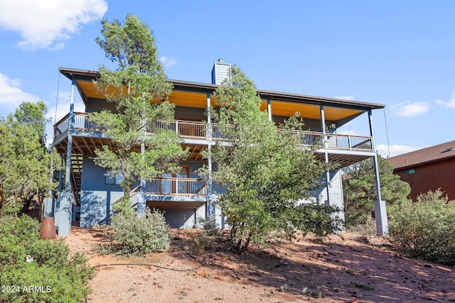 rear view of house featuring a balcony