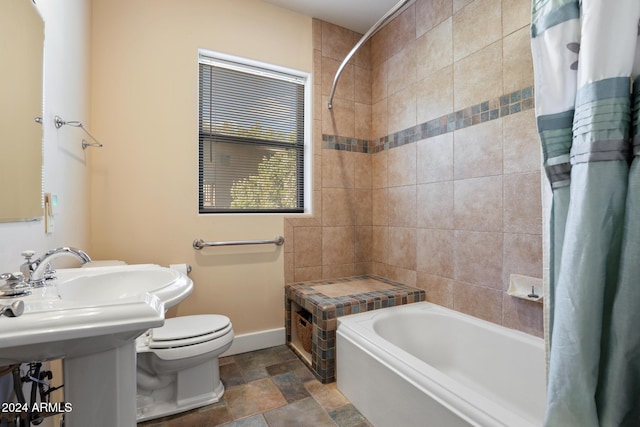 full bathroom featuring sink, shower / tub combo with curtain, and toilet