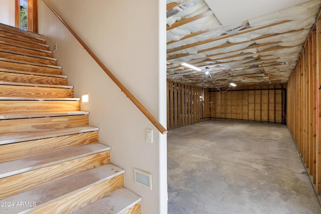 staircase with concrete flooring