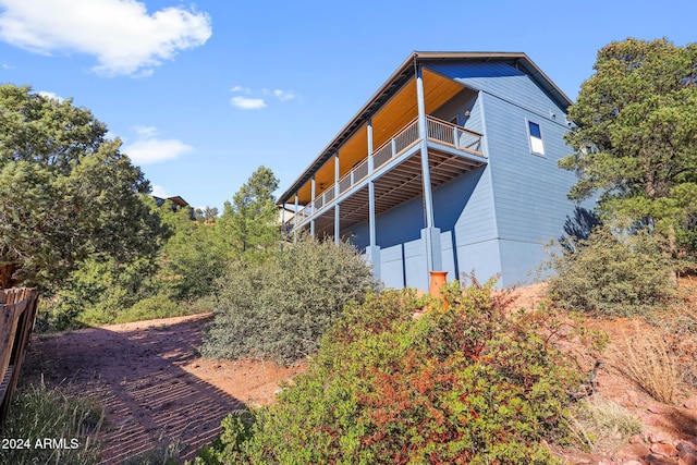 view of side of property with a balcony