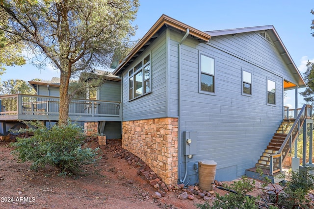 view of side of home with a wooden deck