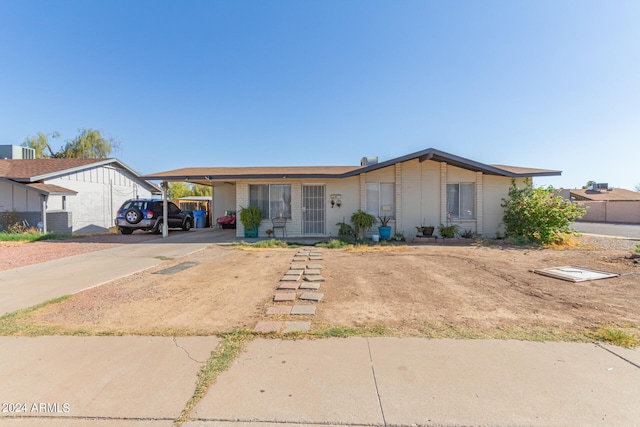 view of front of home with a carport and central air condition unit