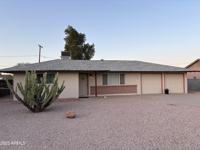 1019 E Granada Ave, Apache Junction, AZ 85119 - ranch-style home with roof with shingles, driveway, an attached garage, and brick siding