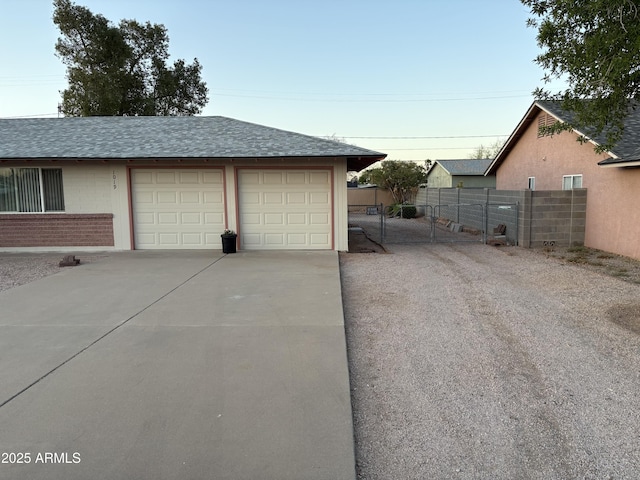 1019 E Granada Ave, Apache Junction, AZ 85119 - garage with concrete driveway and a gate