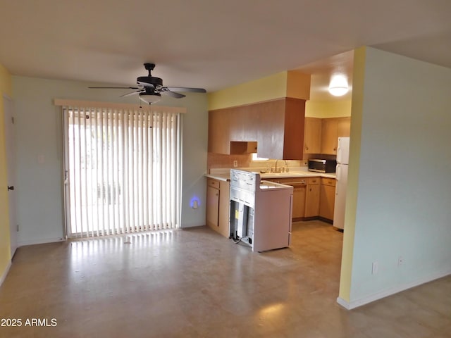 1019 E Granada Ave, Apache Junction, AZ 85119 - kitchen with freestanding refrigerator, a sink, light countertops, ceiling fan, and stainless steel microwave