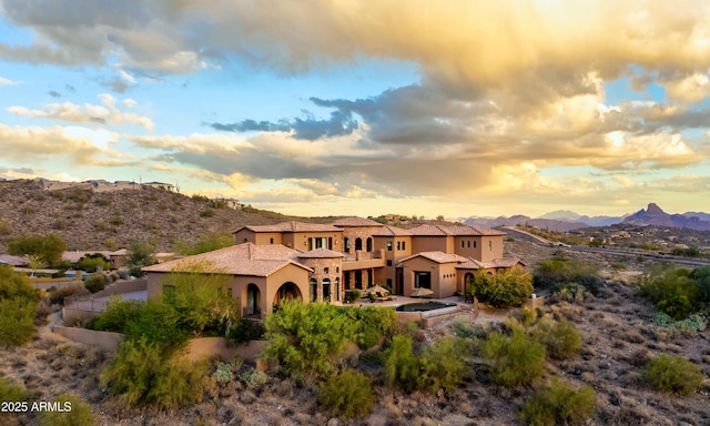 back house at dusk featuring a mountain view