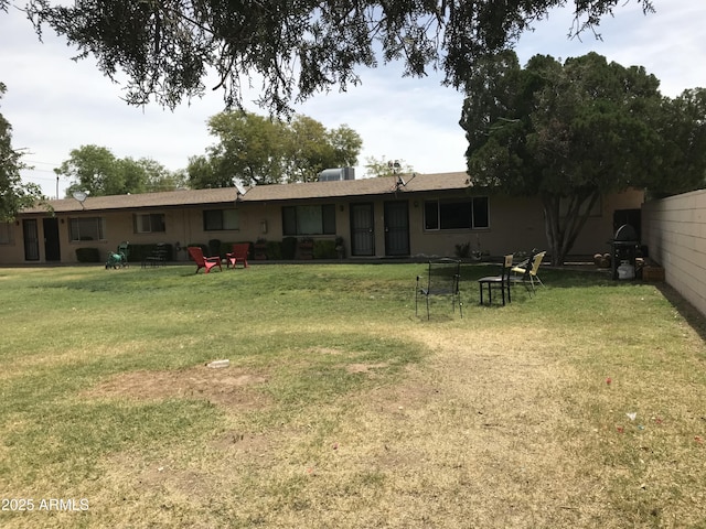 back of house with a lawn
