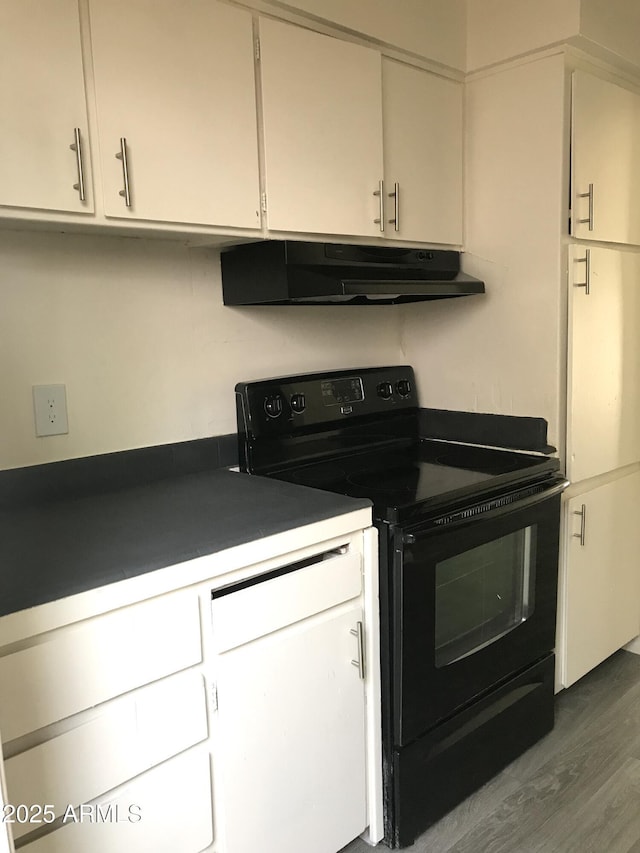 kitchen with dark wood finished floors, black range with electric stovetop, under cabinet range hood, and white cabinets
