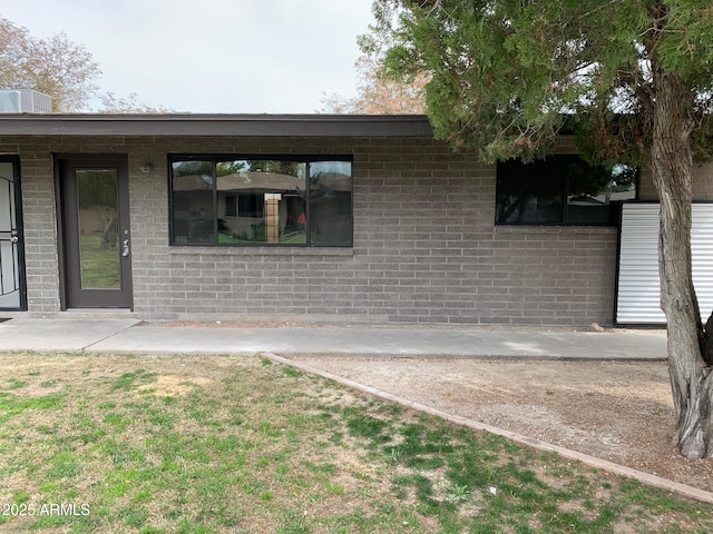 property entrance featuring brick siding