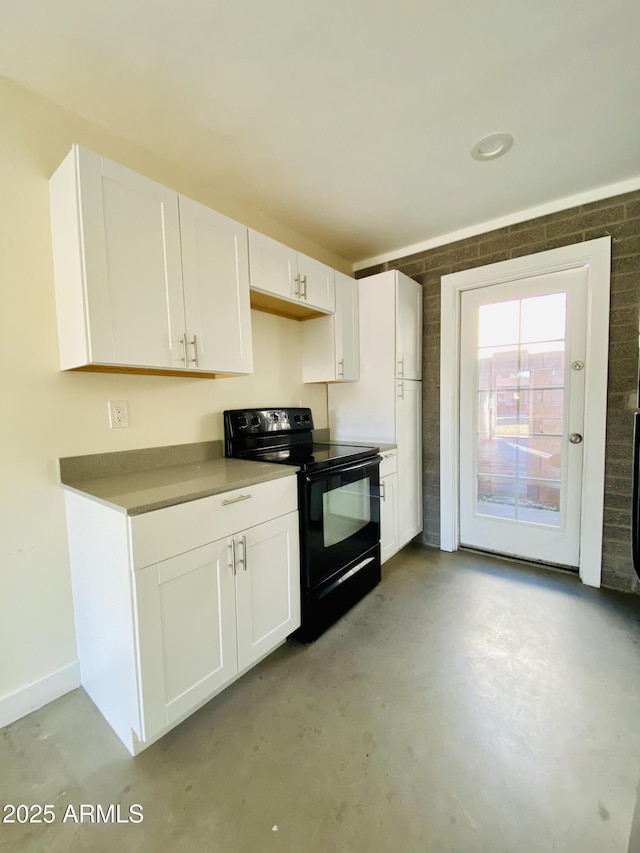 kitchen featuring concrete floors, white cabinetry, and black range with electric stovetop