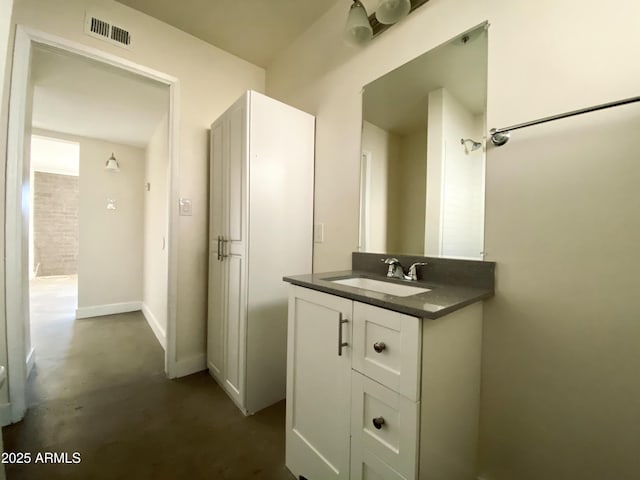 bathroom featuring baseboards, finished concrete flooring, vanity, and visible vents