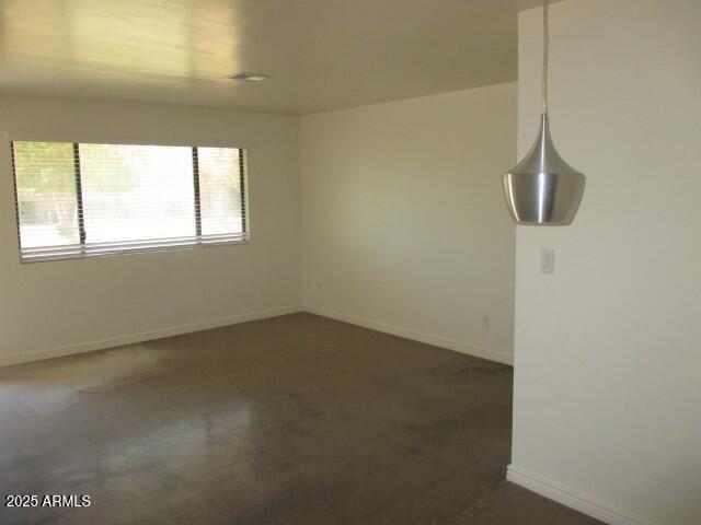 unfurnished room featuring baseboards