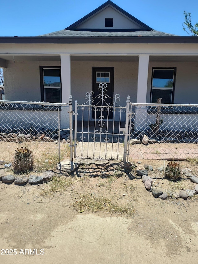 309 W Az Highway 177, Winkelman, AZ 85192 - view of front of house with a porch, a fenced front yard, and stucco siding