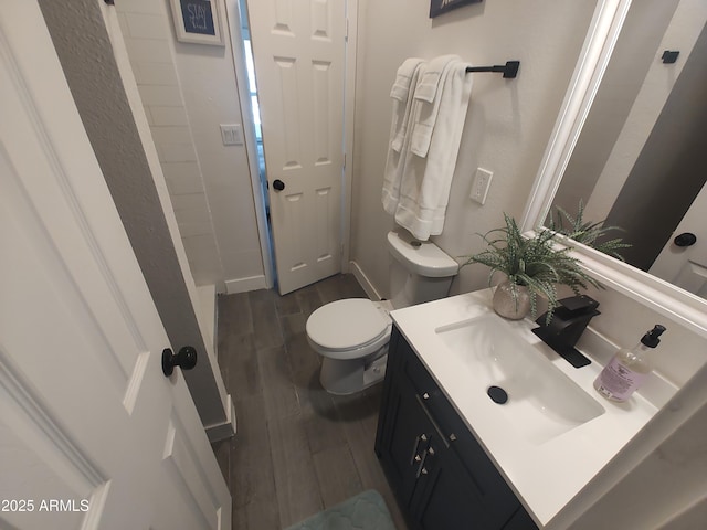 309 W Az Highway 177, Winkelman, AZ 85192 - bathroom with wood finished floors, toilet, vanity, and baseboards
