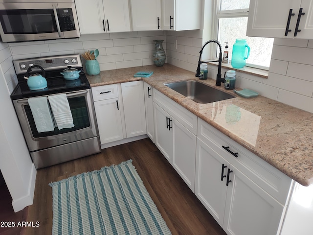 309 W Az Highway 177, Winkelman, AZ 85192 - kitchen with stainless steel appliances, a sink, white cabinetry, dark wood-style flooring, and backsplash