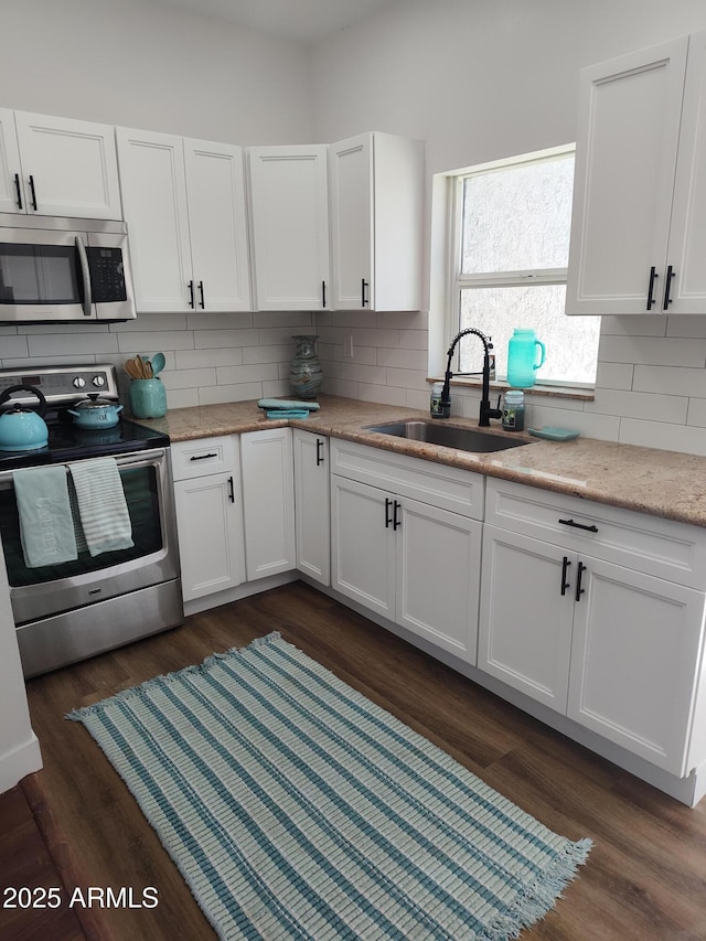 309 W Az Highway 177, Winkelman, AZ 85192 - kitchen with stainless steel appliances, a sink, decorative backsplash, and white cabinets