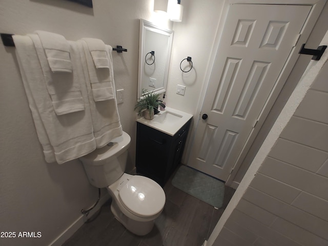 309 W Az Highway 177, Winkelman, AZ 85192 - half bathroom with wood finished floors, vanity, toilet, and baseboards