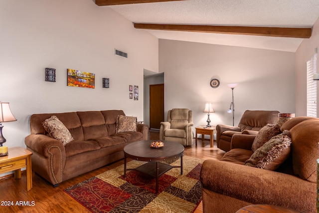 living room featuring lofted ceiling with beams, dark hardwood / wood-style flooring, and a textured ceiling