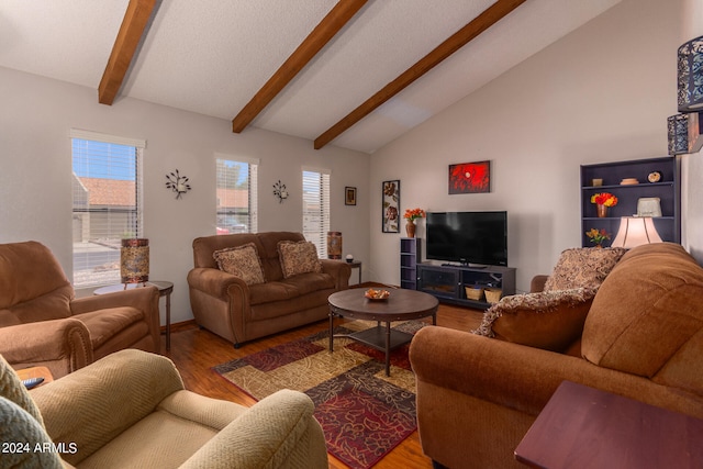 living room featuring hardwood / wood-style flooring and vaulted ceiling with beams