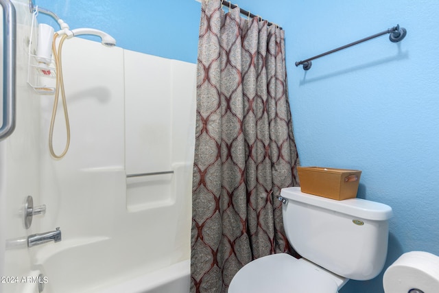 bathroom with toilet and shower / tub combo with curtain