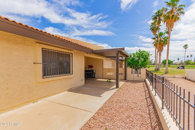 view of property exterior with a patio area