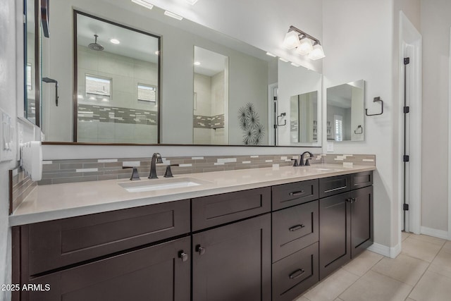 14571 W Wethersfield Rd, Surprise, AZ 85379 - bathroom featuring tasteful backsplash, tiled shower, tile patterned floors, and double vanity