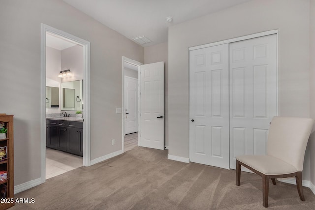 14571 W Wethersfield Rd, Surprise, AZ 85379 - bedroom featuring light colored carpet, a sink, a closet, and baseboards