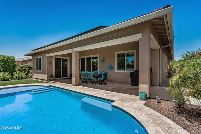 14571 W Wethersfield Rd, Surprise, AZ 85379 - back of property featuring a patio area, stucco siding, and an outdoor pool
