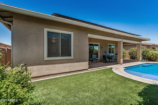 14571 W Wethersfield Rd, Surprise, AZ 85379 - rear view of house featuring a patio area, stucco siding, and an outdoor pool