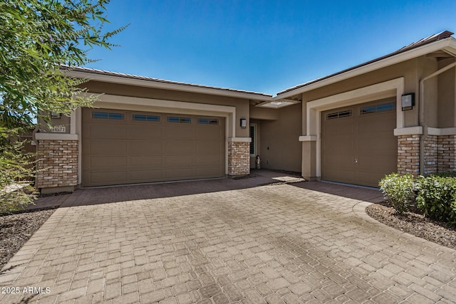 14571 W Wethersfield Rd, Surprise, AZ 85379 - view of front of home with brick siding, an attached garage, decorative driveway, and stucco siding