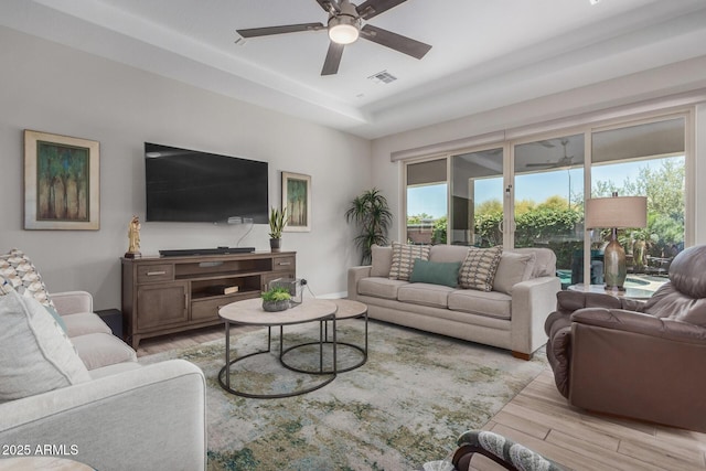 14571 W Wethersfield Rd, Surprise, AZ 85379 - living room featuring light wood-type flooring, a ceiling fan, and baseboards