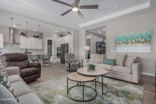 14571 W Wethersfield Rd, Surprise, AZ 85379 - living room with light wood-type flooring, a ceiling fan, recessed lighting, and baseboards