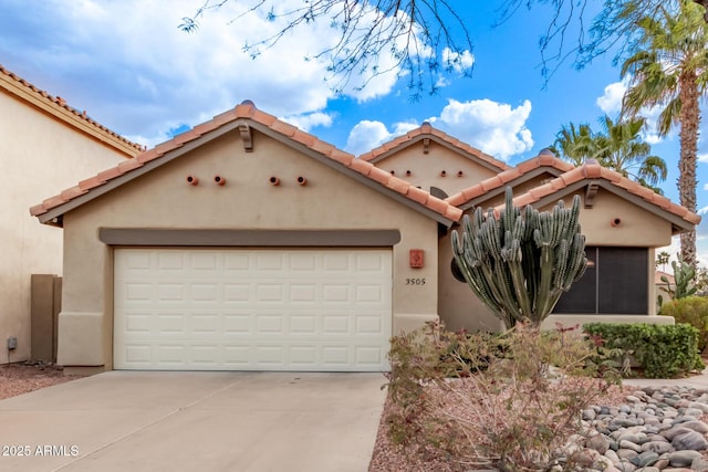 view of front of home featuring driveway, a tile roof, and stucco siding